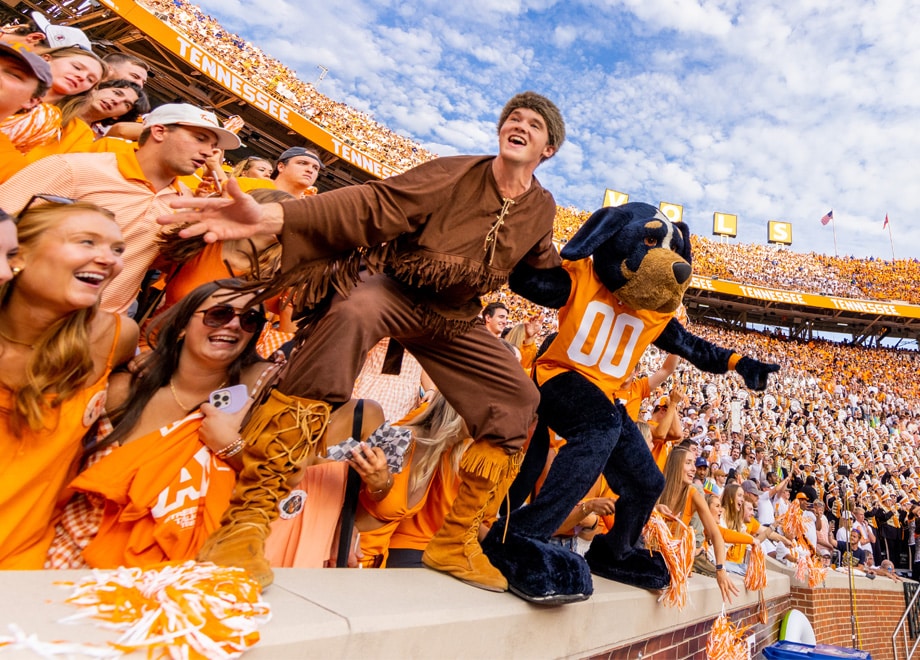 Davy Crockett and Smokey with fans at a football game
