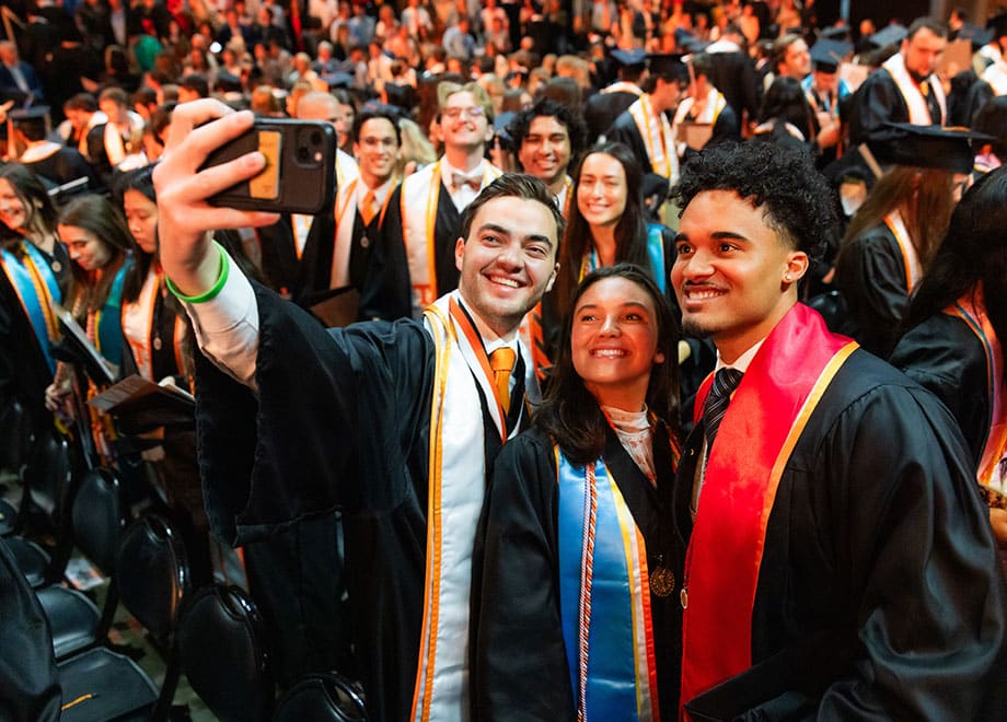 Graduates take a selfie during commencement