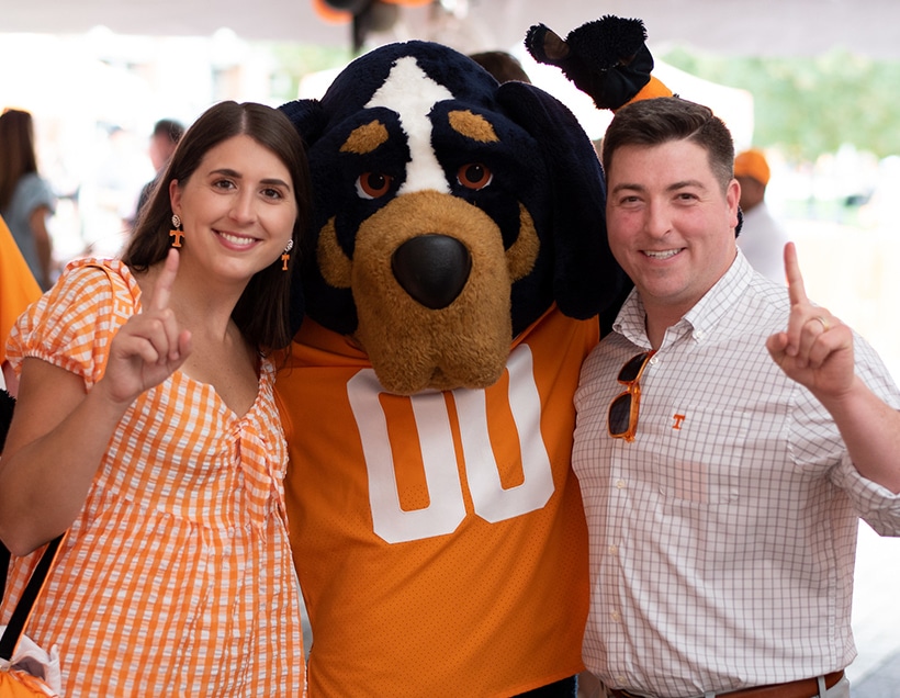 Two young alumni pose with Smokey