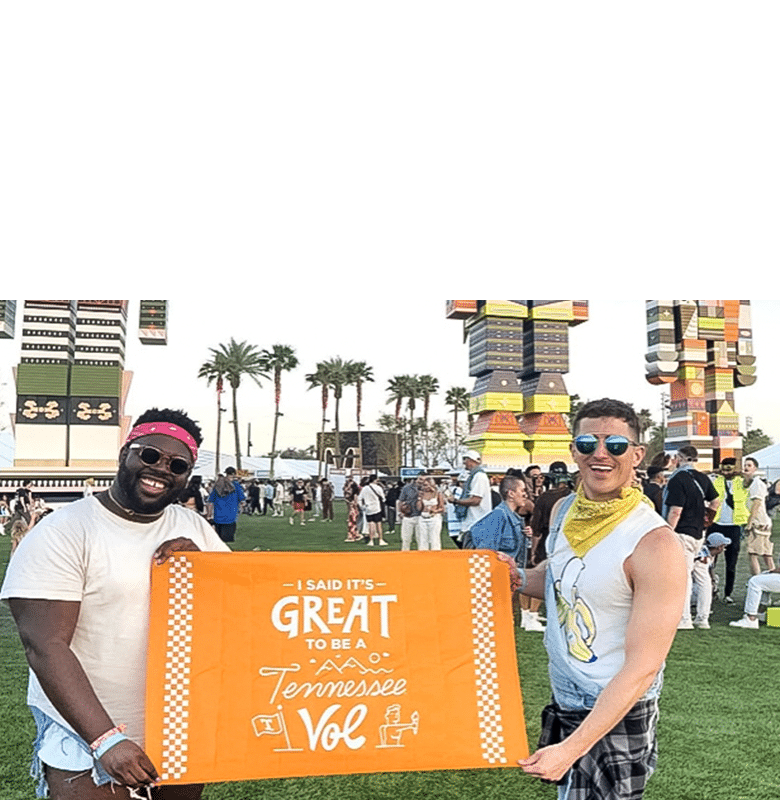 Two Vols hold a flag that says It's Great to Be a Tennessee Vol