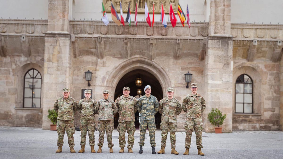 UT Knoxville Army ROTC Cadets stand in front of a building in Austria