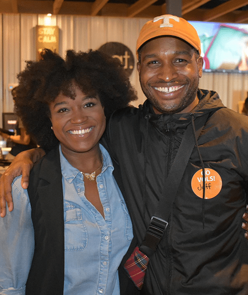 A man wearing a Tennessee Volunteers baseball cap and a woman smile for a photo