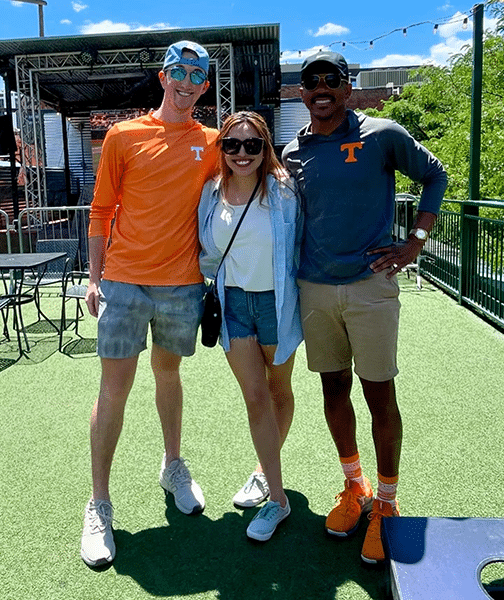 Three Vol fans pose for a photo during a Vol Watch Party