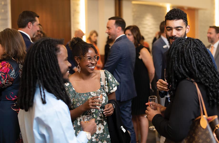 Four alumni chatting during the Alumni Awards Gala