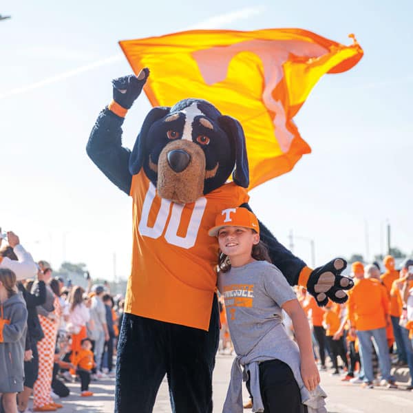 Smokey poses for a photo with a young Vol fan