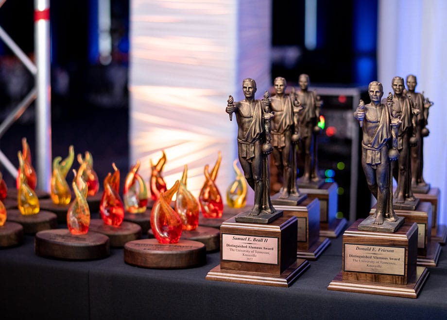 Alumni awards shaped like flames and the Torchbearer