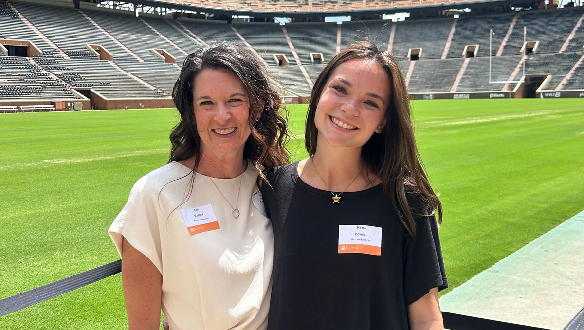 Kim Marden and her daughter Kyra Powell post for a photo with Neyland Stadium in the background. The V-O-L-S letters can be seen behind them.