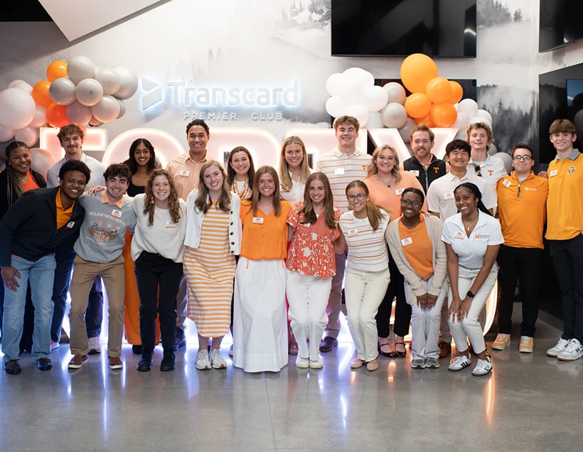 activities-saa-students A group of Student Alumni Associates take a photo in front of orange and white balloons.