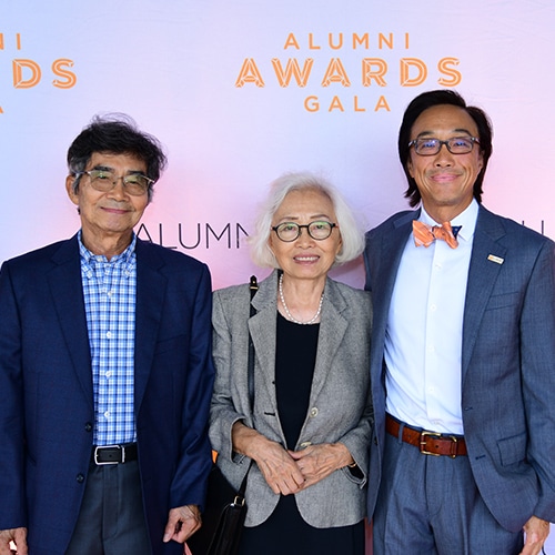 alumni-awards-group-24 Three alumni stand in front of an Alumni Awards Gala backdrop.
