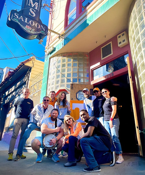 chapters-watch-party-group A group poses for a photo outside an ornate building.