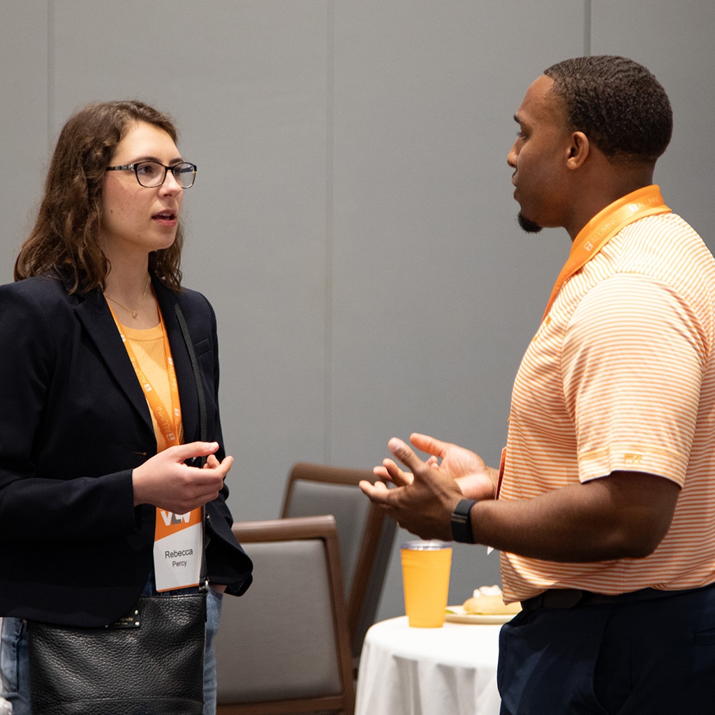 gallery-networking Two alumni chat during a networking event.