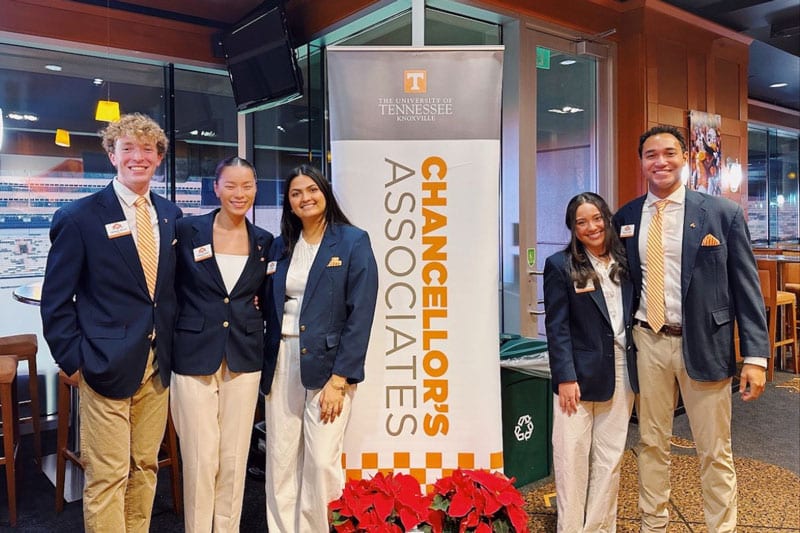 phelps-tatiana-saa-chancellors-associates-800x533 Tatiana Phelps and 4 fellow Student Alumni Associates pose for a photo next to a Chancellor's Associates banner.