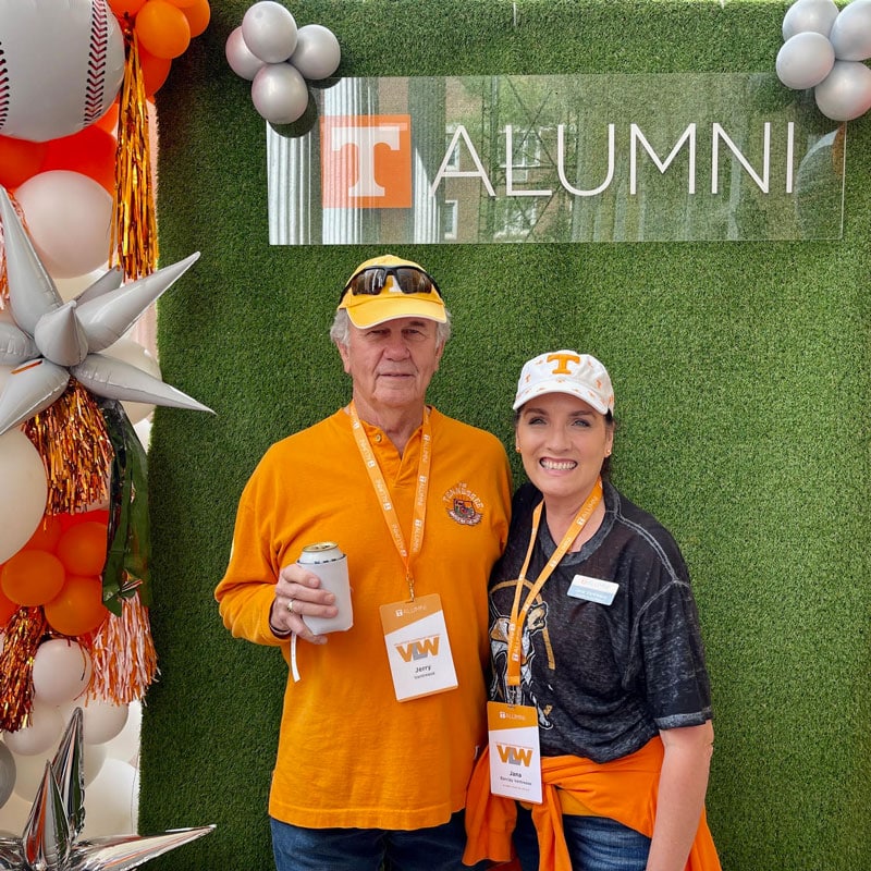 vantrease-jana-and-jerry-home-sweet-home-tailgate-2-800x800 Jerry Vantrease and his daughter Jana Vantrease pose for a photo in front of the UT Alumni backdrop during a Home Sweet Home tailgate.