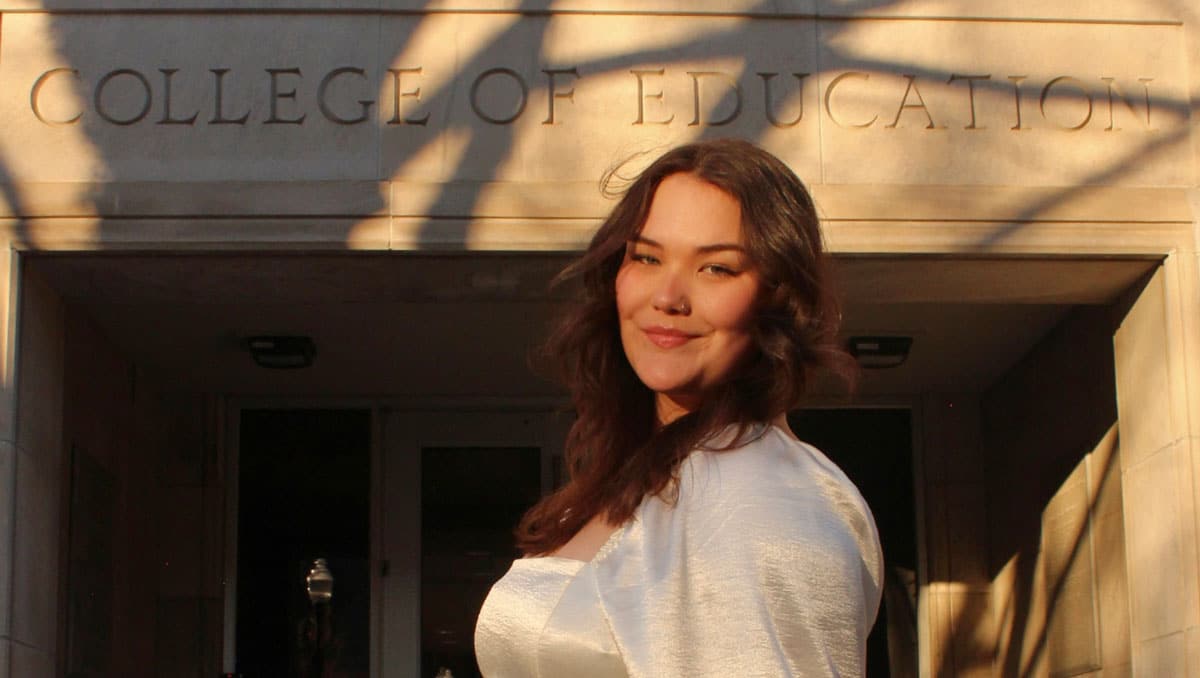 Sienna Reid in front of the College of Education building.