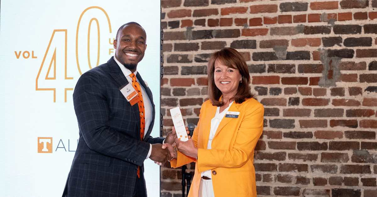 man and woman shaking hands at 40 under 40 event