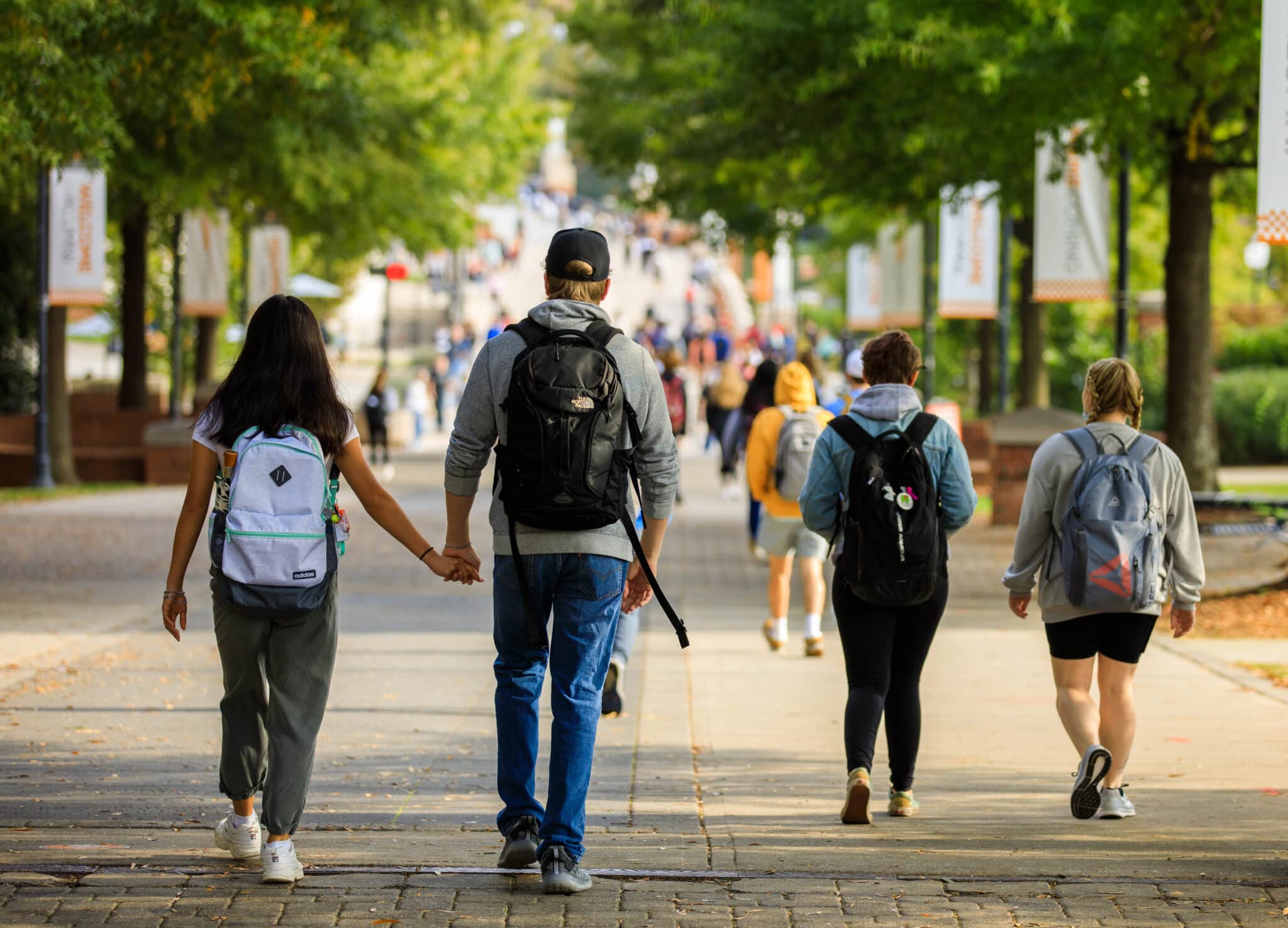 Students hold hands while walking down Ped walkway on October 25, 2021. Photo by Steven Bridges/University of Tennessee.