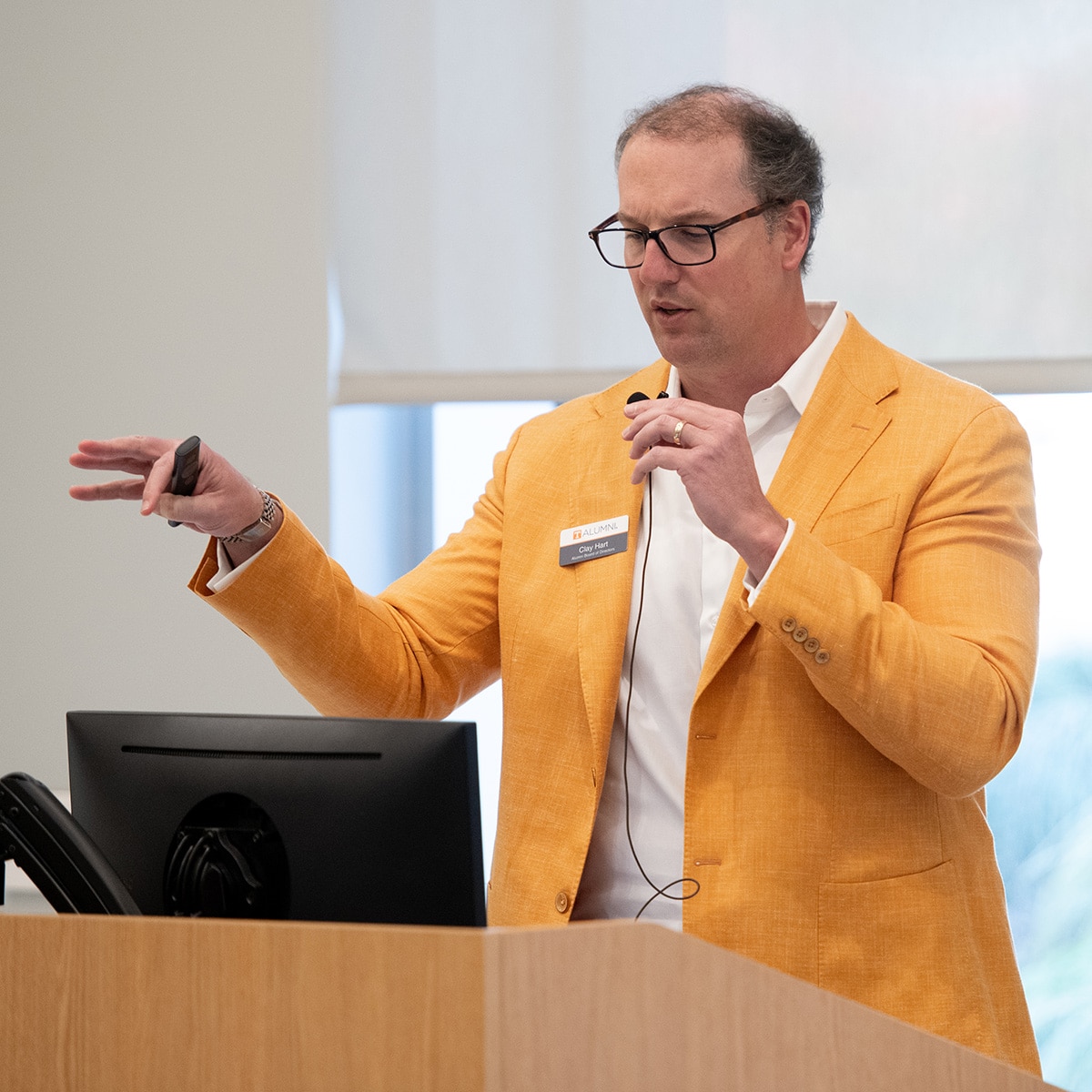 Clay Hart speaking at a podium 