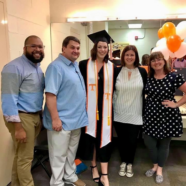 Graduation-&-University-Events-Team-2 5 people smiling with one person in graduation attire