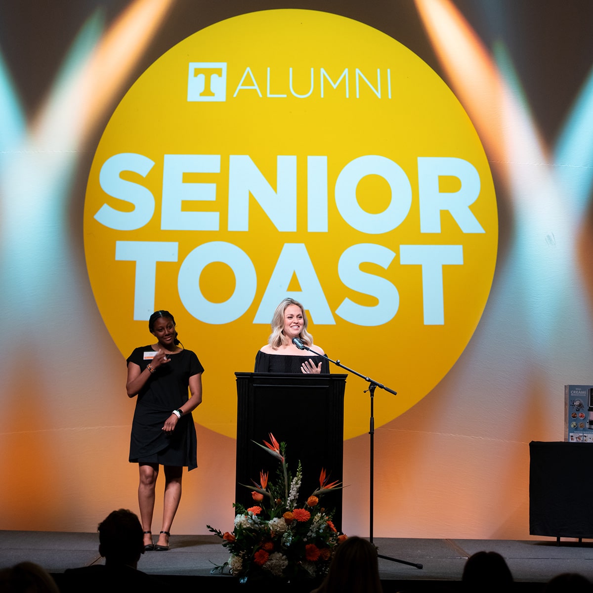 Sierra Garvin speaking at event with the words Senior Toast behind her
